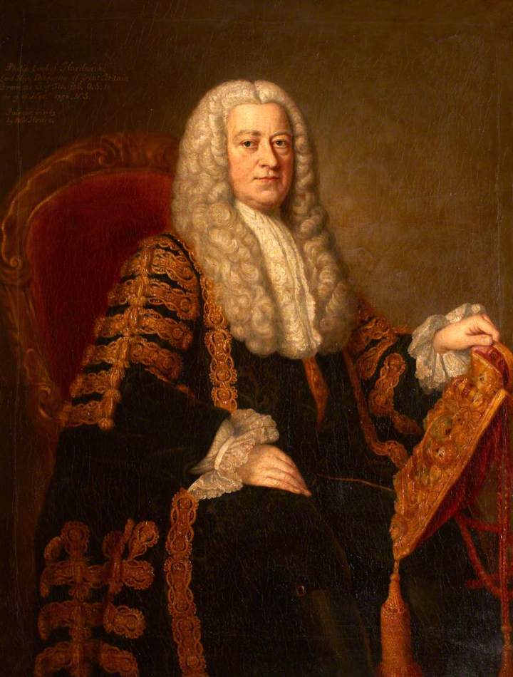 A half-length portrait of a man sitting in an ornate red velvet cushioned chair.  He is wearing the robes of the keeper of the Great Seal, which is a black robe with ornate gold detailing covering the arms and lapels of the robe. He is wearing a white shirt with frilled lace cuffs and a frilled lace neckcloth. He has long grey curly hair down to the chest. He is holding in his left hand a richly decorated ceremonial purse that contains the great seal of the realm. 