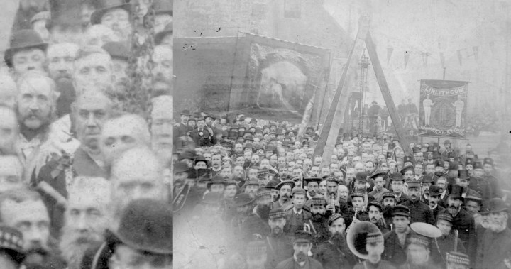A group outdoors scene of hundreds of men and women, some with instruments, some with banners, grouped around a large steel tripod with chains