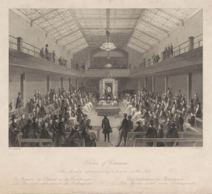 A line engraving titled 'House of Commons, the Speaker reprimanding a person at the bar'. In the foreground there is a walkway into the middle of the room, with two rows of benches either side. The middle of the room has a table with the despatch boxes on top. Behind the table stands the Speaker with his wig and robe. Either side of the room are four rows of benches, with a viewing gallery above. The room is full of MPs sitting on the benches and a few viewing from the gallery.
